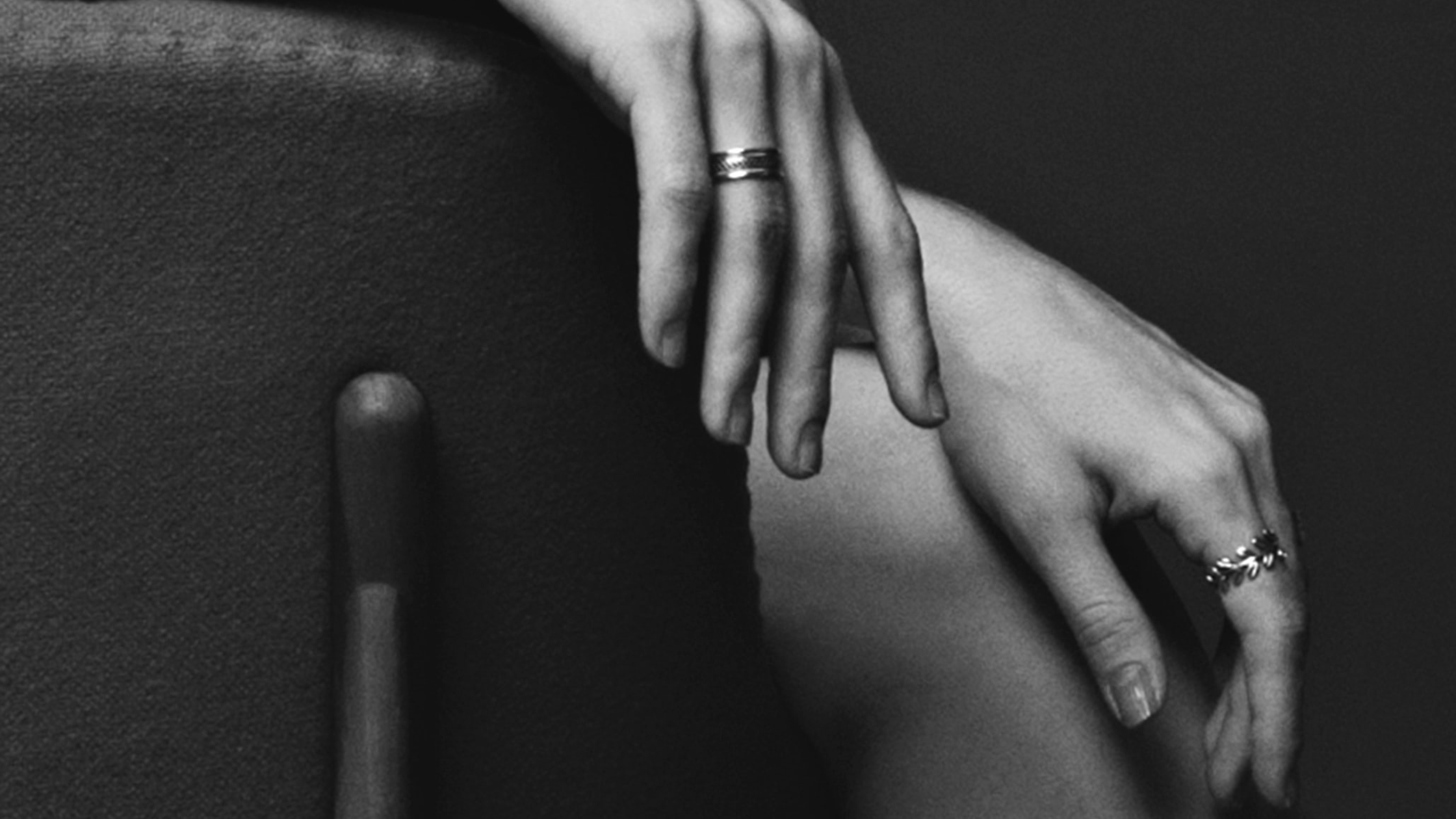 black and white photo of woman's hands wearing rings divine feminine energy in business